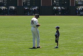 Barry Bonds signs an autograph before a Giants game