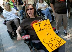 Protesters with ADAPT demand funding for Medicaid outside the White House in 2010